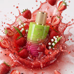 MELITE PARFUMS Intoxicating Femininity EDP bottle surrounded by fresh strawberries and lily of the valley in a splash