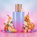 MELITE PARFUMS Intoxicating Femininity Absolute EDP bottle surrounded by pears, caramel, and candy on a gradient background