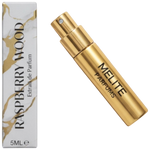 MELITE PARFUMS Raspberry Wood extrait de parfum travel spray in a gold metallic bottle next to its marble-patterned box