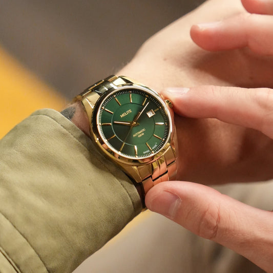 MELITE PARFUMSH Men's gold PVD stainless steel automatic watch with emerald green sunburst dial and date window.